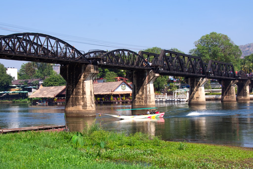 View of the bridge and river from the river bank. The floating restaurant can be seen behind the bridge.